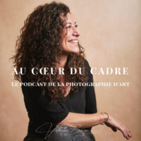 Photographe d'art pensif devant son appareil, illustrant le coût du perfectionnisme et la frustration silencieuse